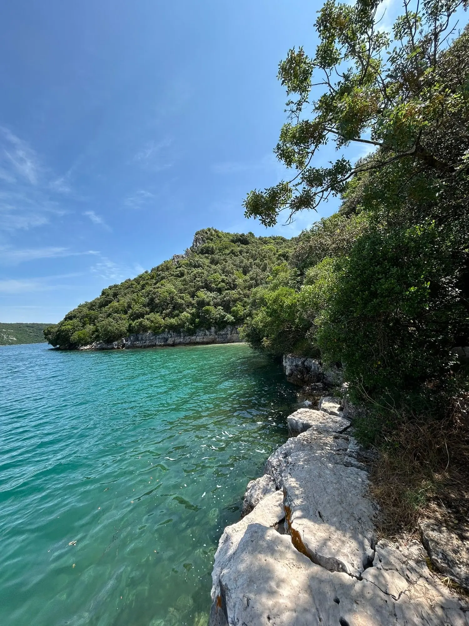 A quiet pebble beach along the Lim Fjord
