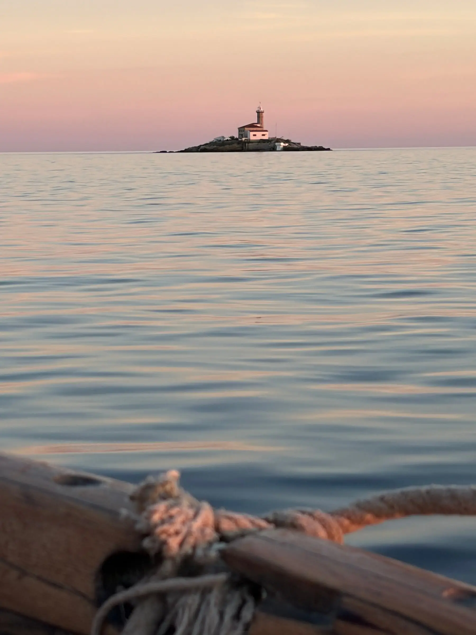Lighthouse on a small island near Rovinj at dusk
